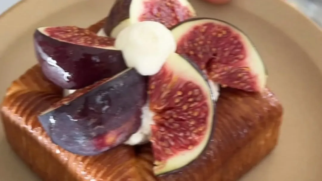 A square laminated pastry topped with fresh figs and cream at Slow