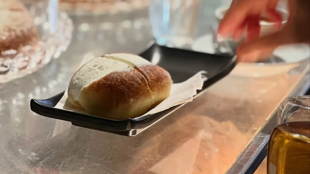 A maritozzo with cream served on the counter at Roscioli Caffè