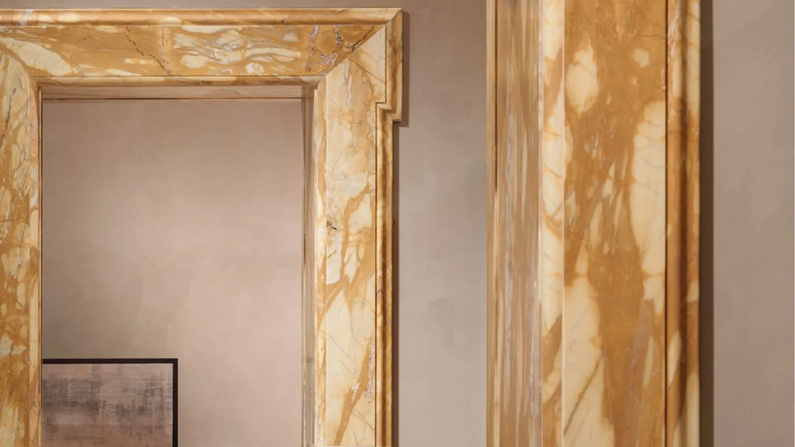 Doorways framed in golden veined marble, with two upholstered chairs visible in the room beyond