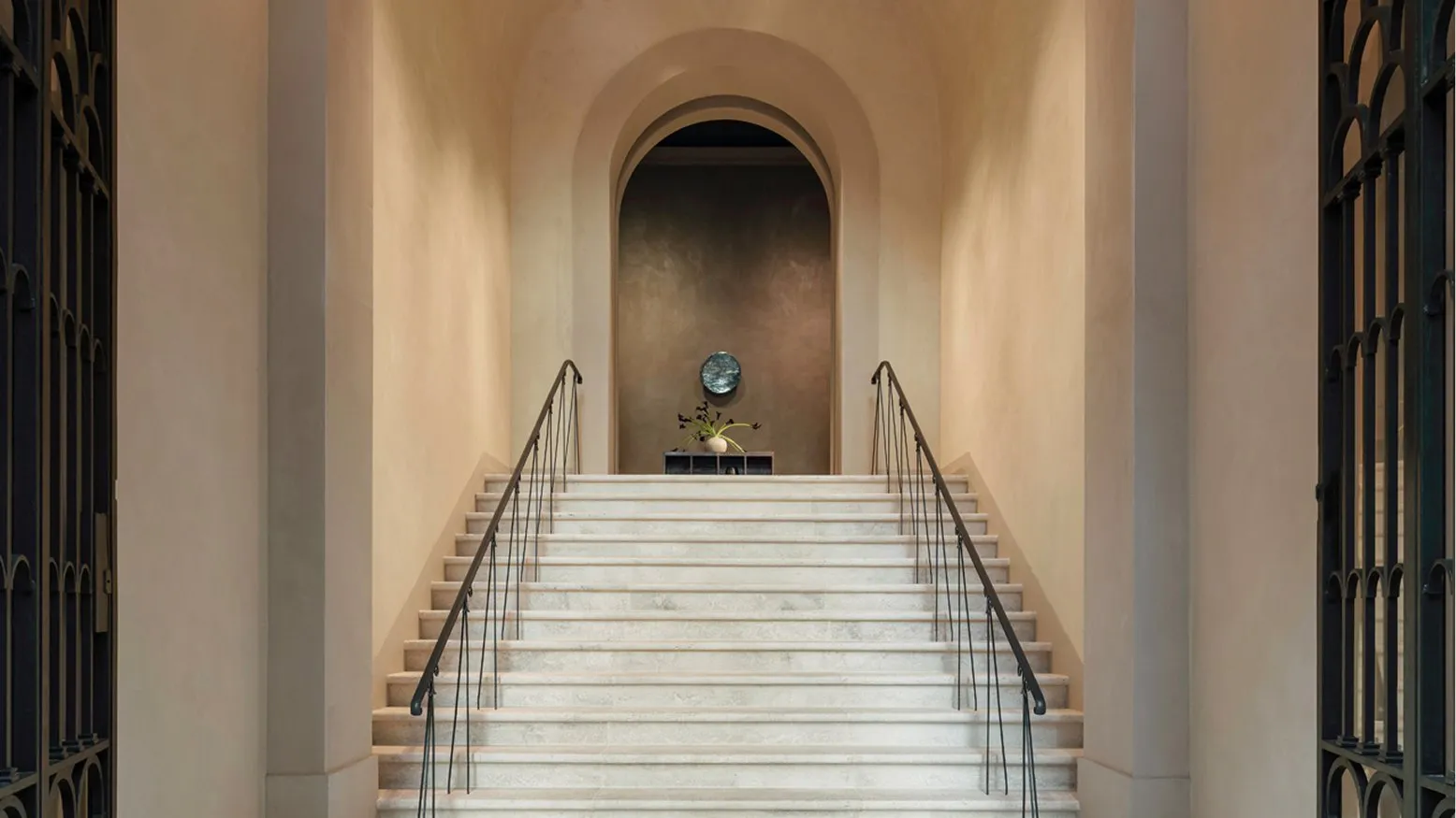 The entrance hall of Palazzo Ruspoli: a vaulted ceiling dotted with small lights above a wide stone staircase