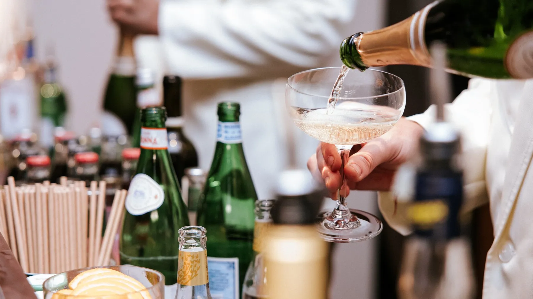 Champagne being poured into a coupe at the bar