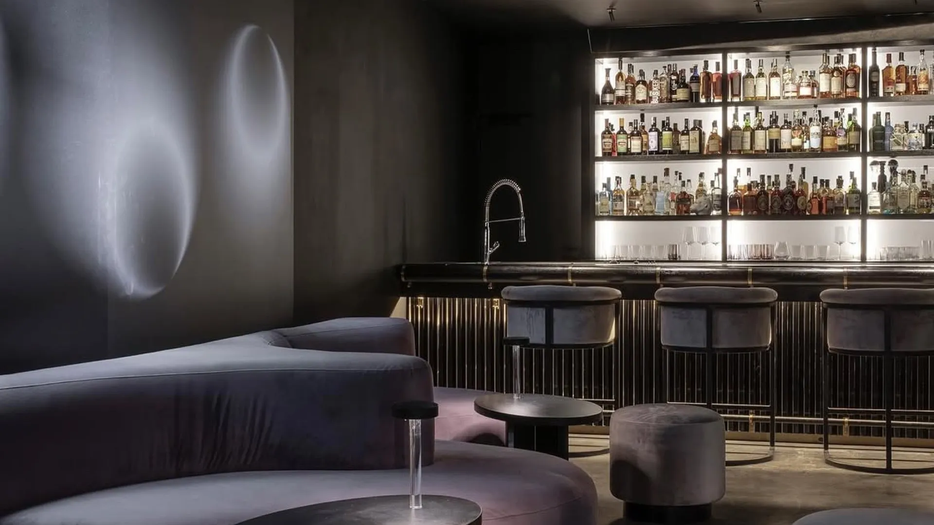 The lounge at Nite Kong, curved velvet seating under a dark ceiling